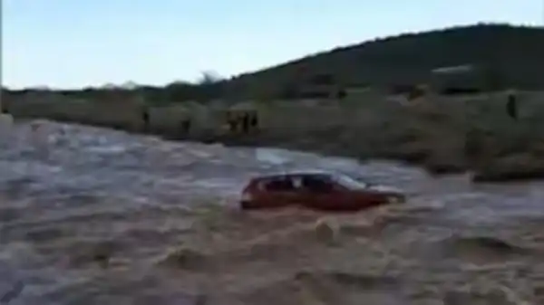 See images from the dramatic helicopter rescue of two men trapped in a flooded creek bed